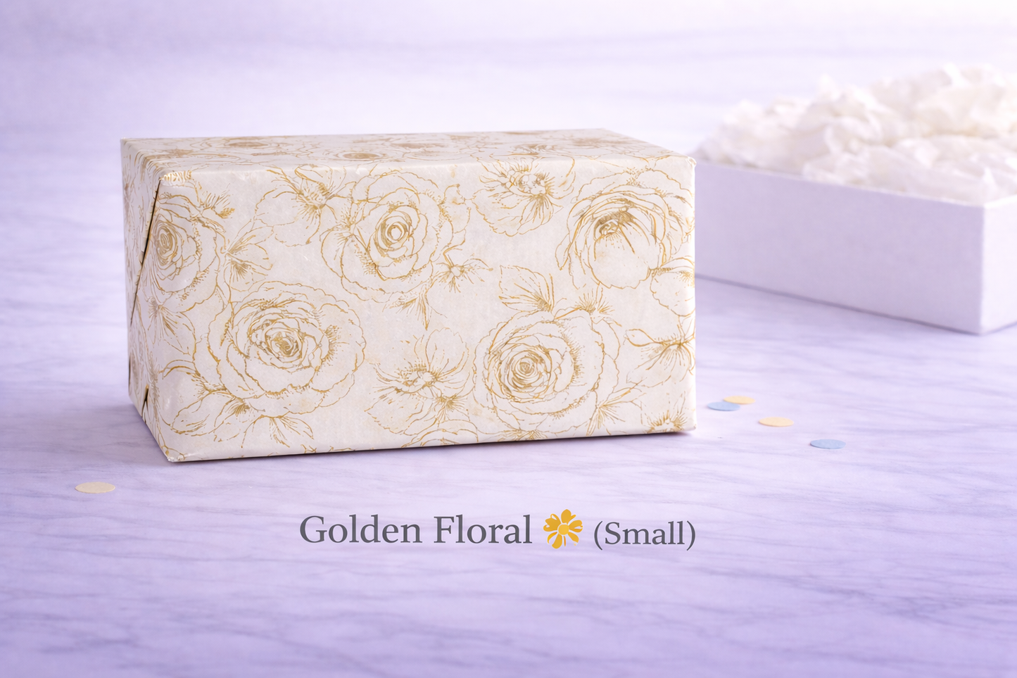 Small box with gold floral pattern on a light purple background